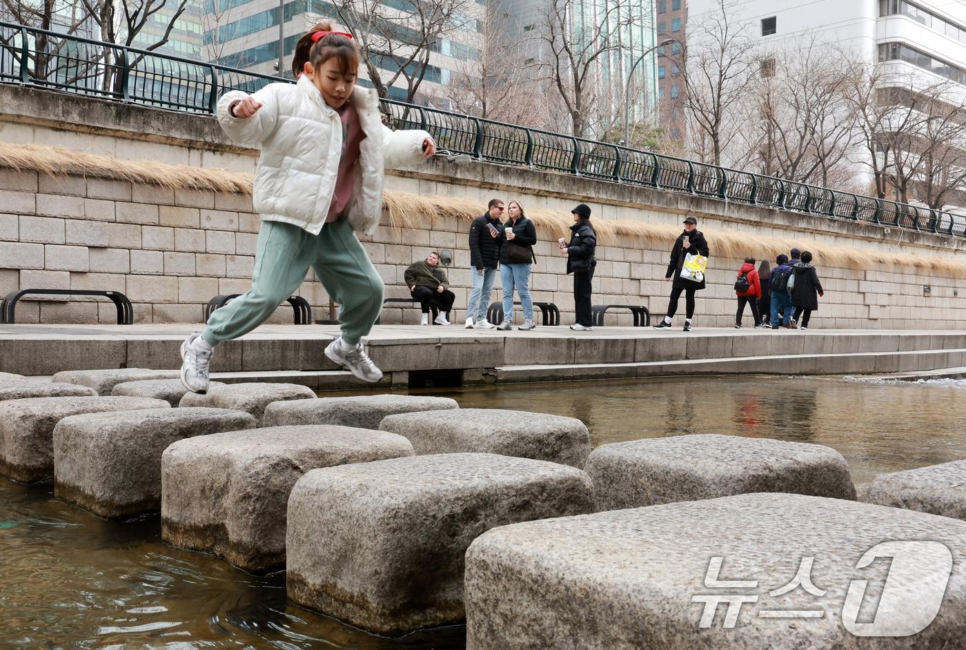 본문 이미지 - 서울 낮 최고 기온이 10도 이상 오르며 포근한 날씨를 보인 22일 오후 서울 청계천을 찾은 관광객들이 산책을 하고 있다. 2026.2.22 ⓒ 뉴스1 이호윤 기자