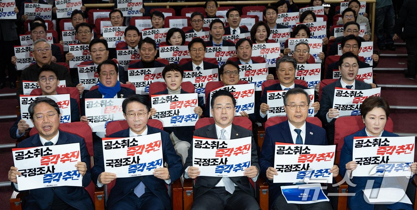 본문 이미지 - 23일 서울 여의도 국회 의원회관에서 열린 더불어민주당 이재명 대통령 사건 공소취소와 국정조사 추진을 위한 의원모임 출범식·결의대회에서 참석자들이 손팻말을 들고 구호를 외치고 있다. 2026.2.23 ⓒ 뉴스1 유승관 기자