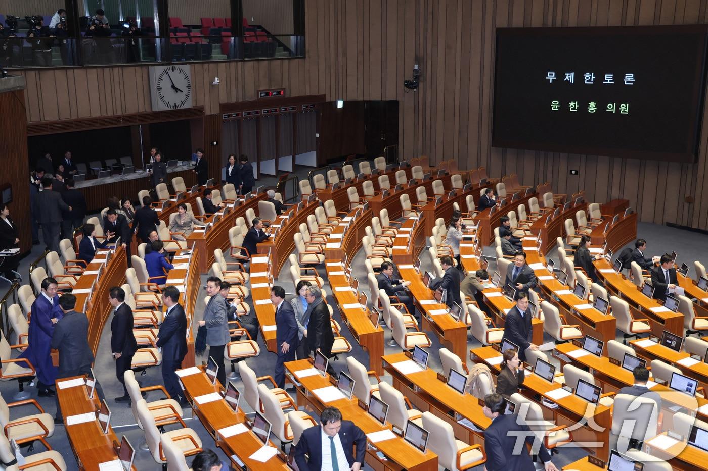 본문 이미지 - 윤한홍 국민의힘 의원이 24일 서울 여의도 국회에서 열린 제432회국회(임시회) 제8차 본회의에서 상법 일부개정법률안(대안)에 대한 무제한 토론(필리버스터)에 돌입하자 더불어민주당 의원들이 퇴장하고 있다. 2026.2.24 ⓒ 뉴스1 신웅수 기자
