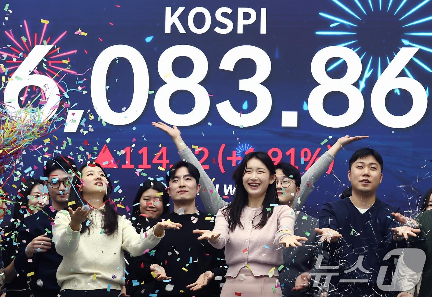 본문 이미지 - 코스피가 6000선을 넘어선 25일 서울 중구 우리은행 본점 딜링룸에서 직원들이 6000선 돌파를 기념하는 세리모니를 하고 있다. 이날 코스피는 전장보다 114.22포인트(1.91%) 오른 6083.86에 거래를 마감했다. 2026.2.25 ⓒ 뉴스1 김민지 기자