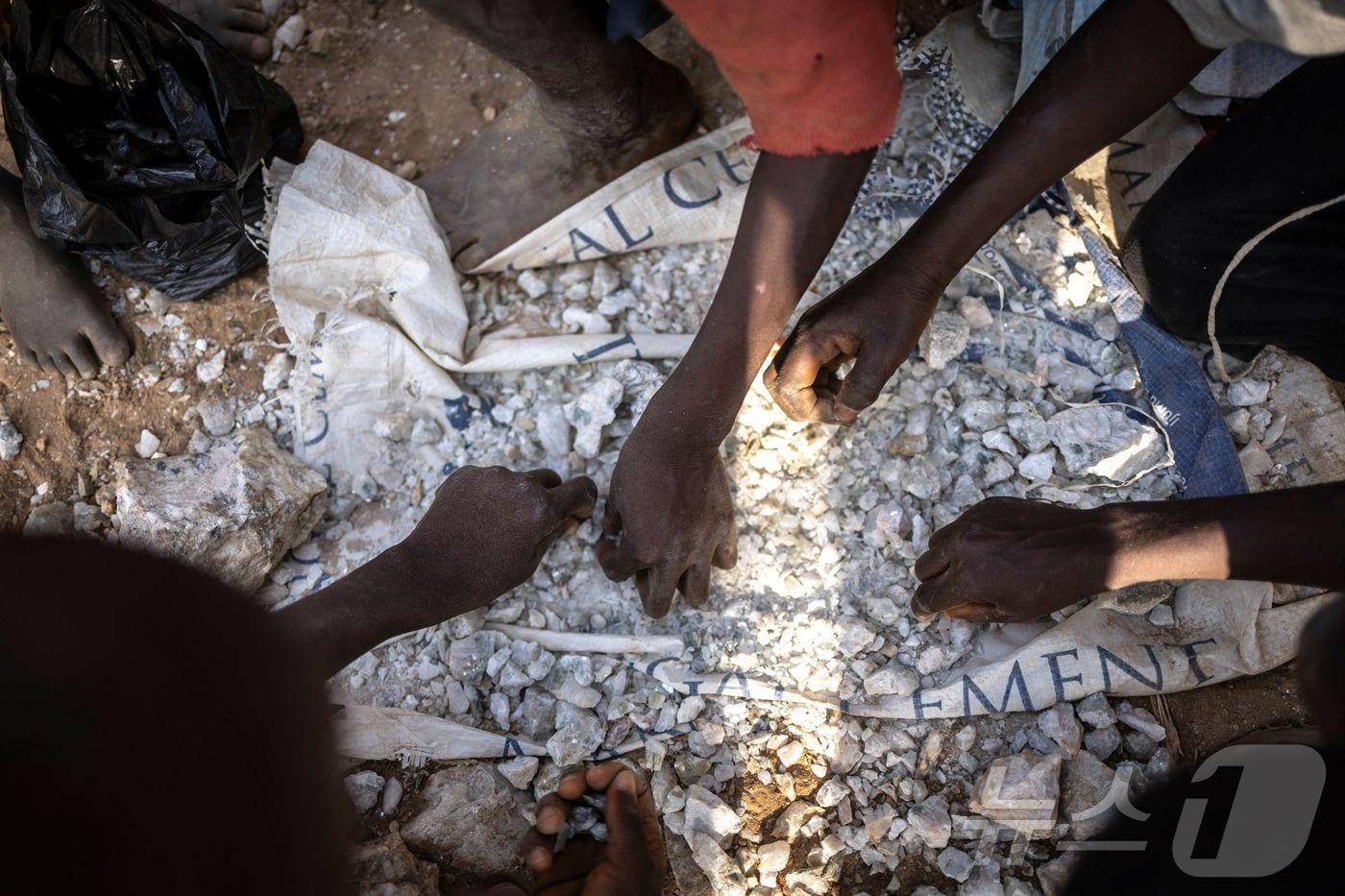 본문 이미지 - 리튬이 함유된 돌을 옮기고 있는 아프리카 나이지리아 어린이들. 2025.01.23.<자료사진>ⓒ AFP=뉴스1