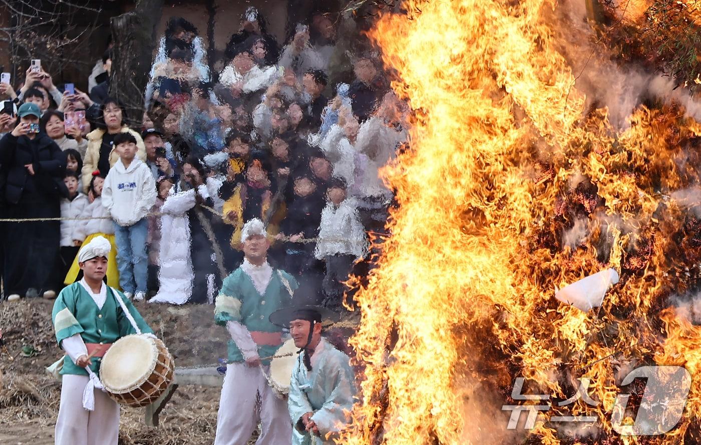 본문 이미지 - 정월대보름을 이틀 앞둔 1일 경기 용인시 기흥구 한국민속촌에서 열린 달집태우기 행사에서 시민들이 타오르는 달집을 바라보며 소원을 빌고 있다. 2026.3.1 ⓒ 뉴스1 김도우 기자