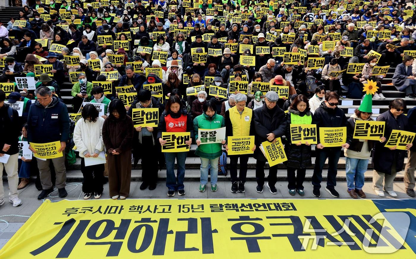 본문 이미지 - 신규핵발전소저지전국비상행동 회원들이 11일 서울 종로구 세종문화회관 계단에서 열린 후쿠시마 원전 사고 15주기 탈핵 선언대회에서 묵념을 하고 있다. 2026.3.11 ⓒ 뉴스1 이호윤 기자