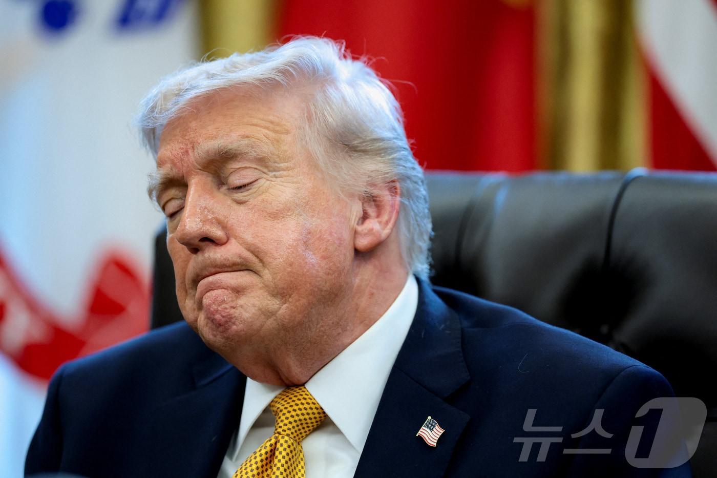 본문 이미지 - 16일(현지시간) 도널드 트럼프 미국 대통령이 워싱턴DC 백악관에서 반(反)부패 태스크포스를 창설하는 행정명령에 서명하는 행사 중 기자의 질문을 받고 어두운 표정을 짓고 있다. 2026.03.16 ⓒ 로이터=뉴스1