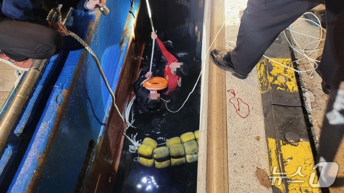 본문 이미지 - 지난 20일 밤 감천항 국제수산물유통센터 앞 해상에서 선박에 승선하던 중 바다로 추락한 A 씨를 해경이 구조하고 있다.(부산해경 제공. 재판매 및 DB금지)