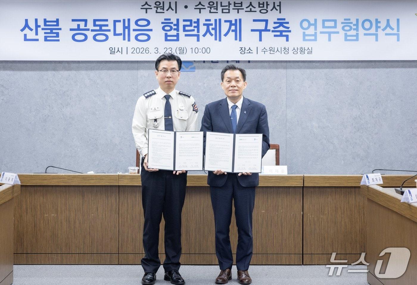 본문 이미지 - 이재준 경기 수원시장(오른쪽)이 23일 박정훈 수원남부소방서장과 '산불 신속 대응을 위한 업무협약'을 맺고 기념촬영을 하고 있다. (수원시 제공. 재판매 및 DB 금지) 2026.3.23/뉴스1