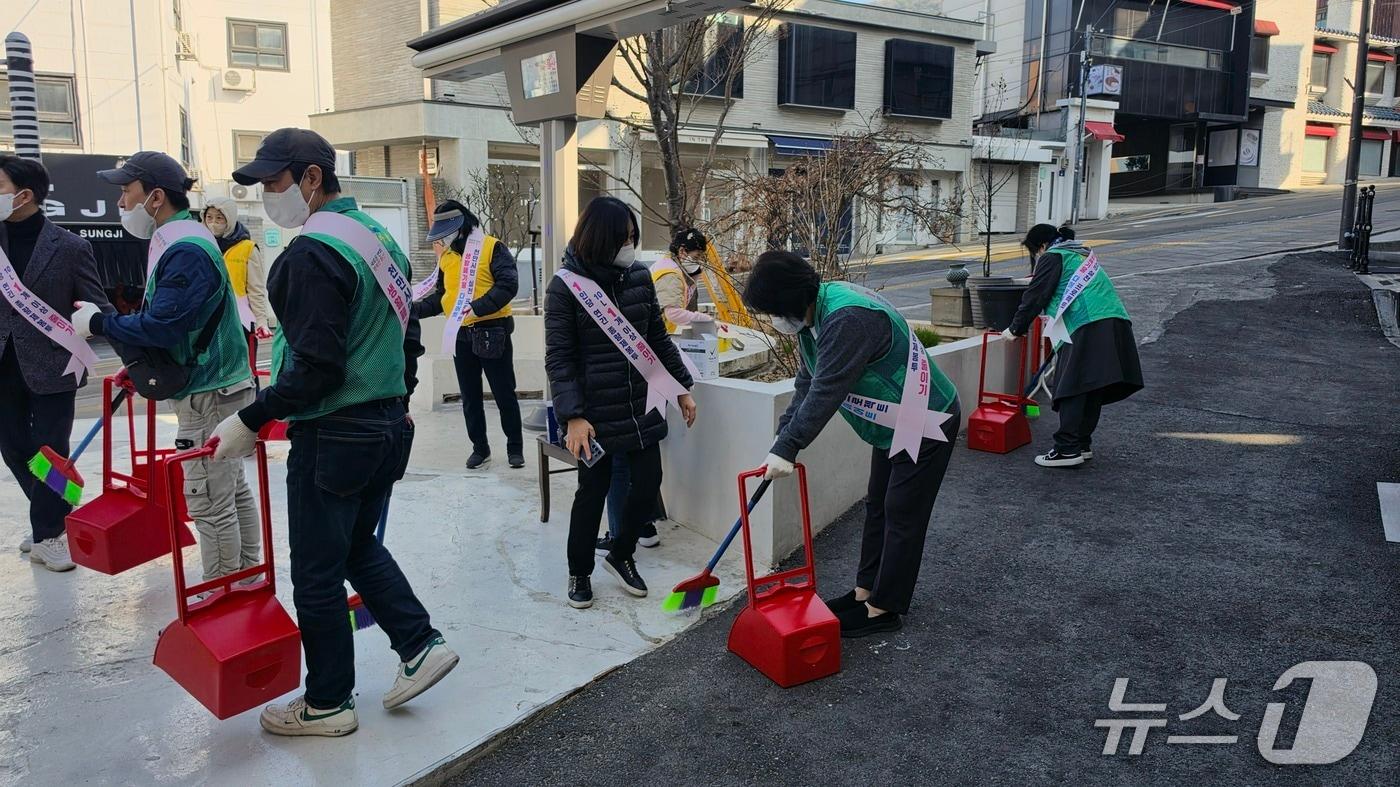 본문 이미지 - 지난 25일 청파동에서 열린 봄맞이 대청소 행사에서 공무원과 지역주민들이 봄맞이 대청소를 하고 있다.(용산구 제공)
