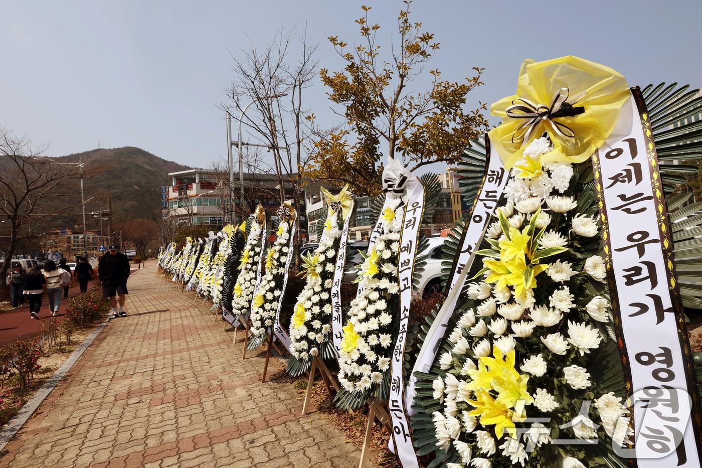 본문 이미지 - 26일 광주지방법원 순천지원 앞 정문에서 부모의 학대로 숨진 생후 4월 아기 '해든이'를 위로하는 근조화환 140여 개가 놓여 있다. 2026.3.26 ⓒ 뉴스1 박지현 기자