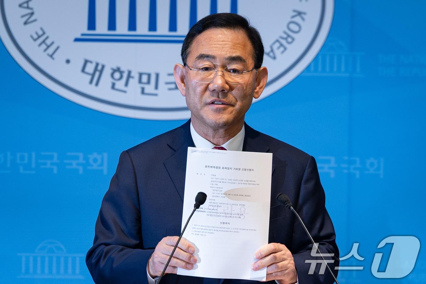 본문 이미지 - 주호영 국민의힘 의원이 26일 서울 여의도 국회 소통관에서 당 공천관리위원회의 대구시장 경선 공천 배제(컷오프)와 관련해 기자회견 중 공천배제결정 효력정지 가처분신청서를 들어보이고 있다. 2026.3.26 ⓒ 뉴스1 유승관 기자