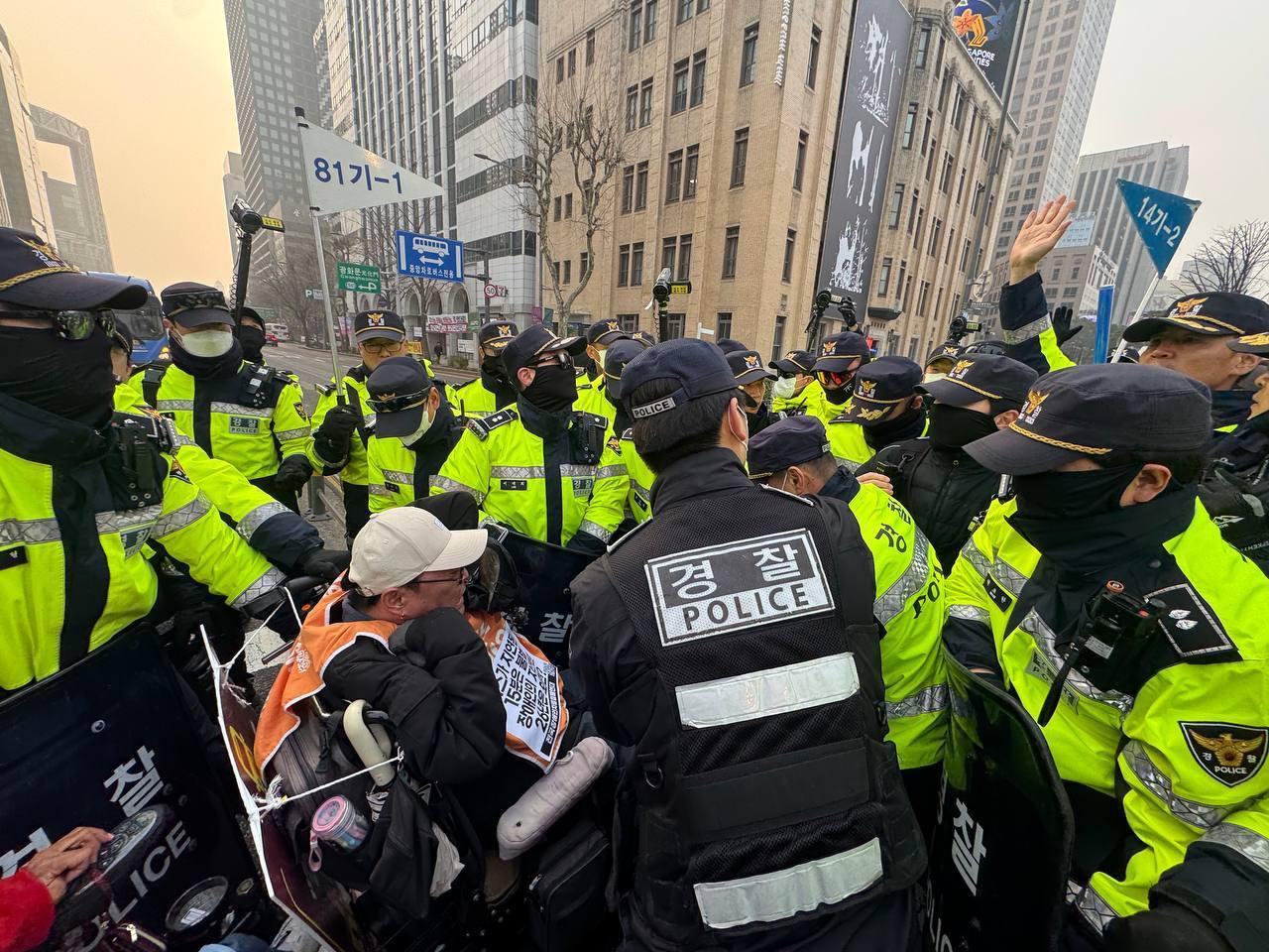 본문 이미지 - 전국장애인차별철폐연대가 27일 서울 광화문 일대에서 버스 탑승 시위를 진행하는 모습(전장연 제공)