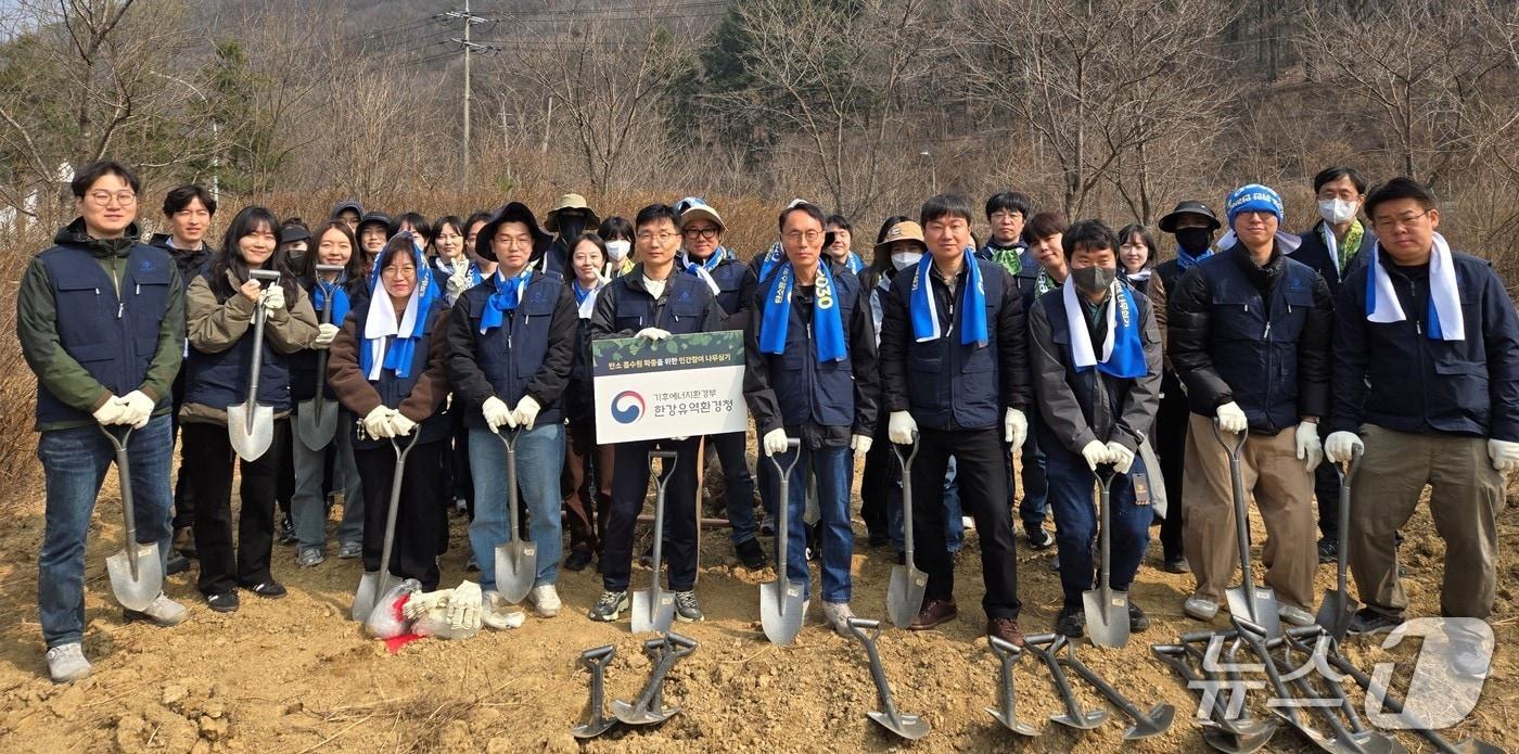 본문 이미지 - 27일 용인시 처인구 경안천 인근에서 열린 식목일 기념 나무심기 행사에서 참가자들이 기념사진을 찍고 있다.(한강청 제공)