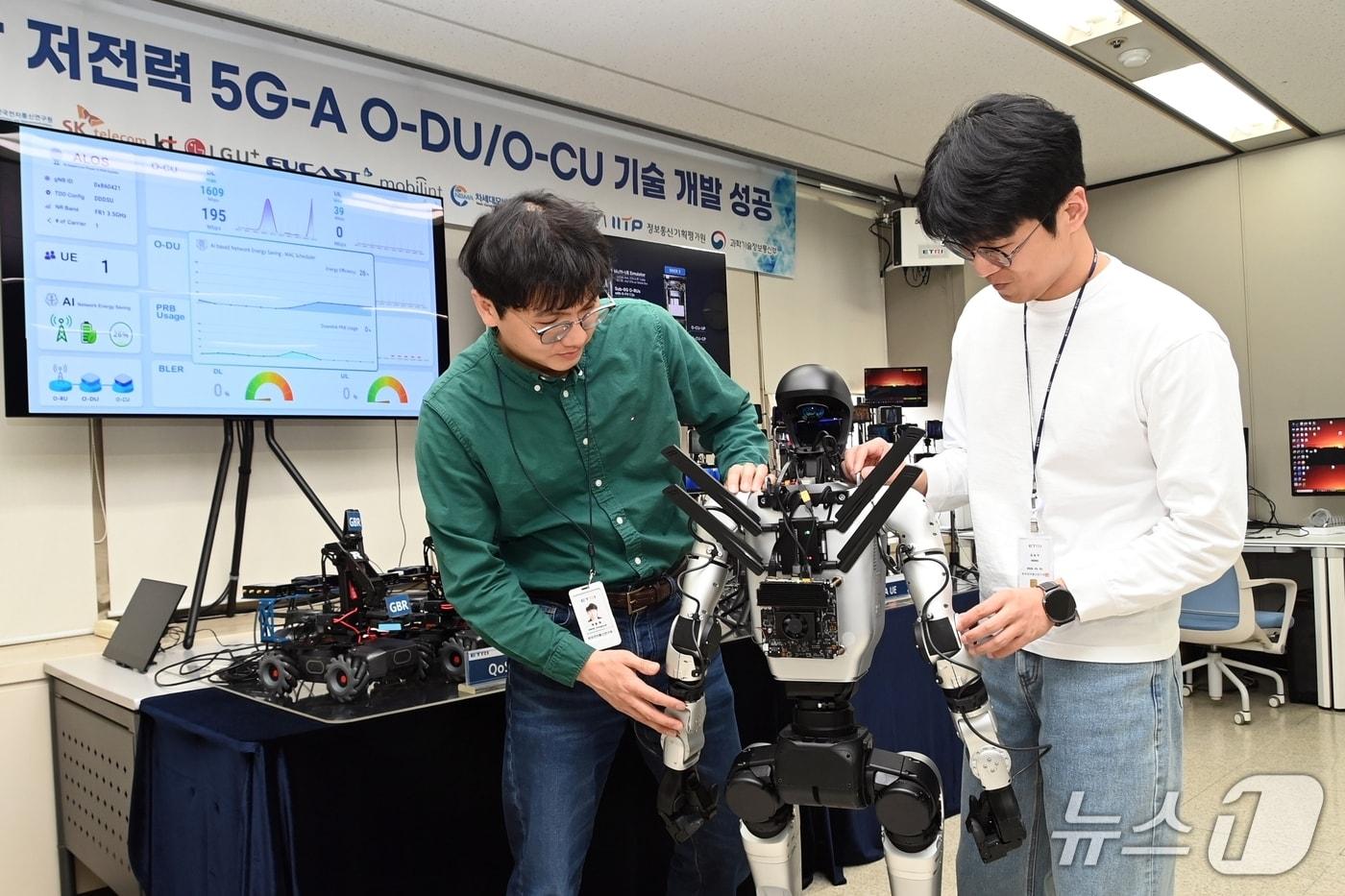 본문 이미지 - 5G모뎀을 설치한 로봇과 오픈랜 저전력 기지국을 연결하는 ETRI 연구진(ETRI 제공) /뉴스1