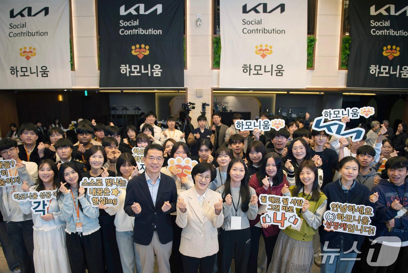 본문 이미지 - 기아의 하모니움 교육 프로그램 2기 수료식 및 3기 입학식 행사 '하모니 데이' 개최 기념촬영. 첫번째 줄 왼쪽에서 6번째부터 이덕현 기아 지속가능경영실 상무, 원민경 성평등가족부 장관(기아 제공)