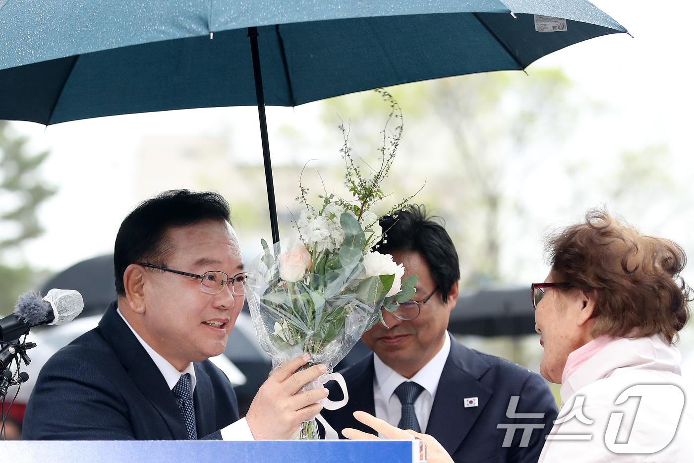 본문 이미지 - 김부겸 전 국무총리가 30일 오후 대구 중구 2·28기념중앙공원에서 6·3지방선거 대구시장 출마를 선언한 뒤 한 시민이 건넨 꽃다발을 받고 있다. 2026.3.30 ⓒ 뉴스1 공정식 기자