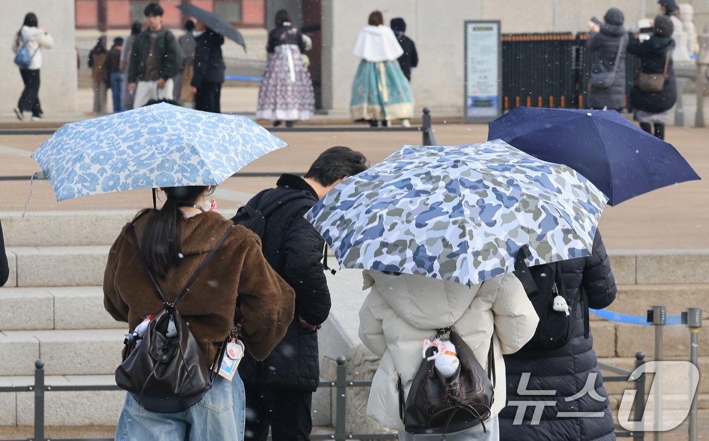 본문 이미지 - 6일 서울 종로구 경복궁 앞에서 관광객들이 우산을 쓰고 지나고 있다. 이날 기상청 적설 관측에 따르면 서울은 오전 9시 기준 서대문에서 0.1㎝의 적설이 관측됐다. 다만 서울 도심에서는 오전 9시 20분 전후 약 10분가량 강한 눈이 내린 뒤 그쳤다. 2026.3.6 ⓒ 뉴스1 임세영 기자