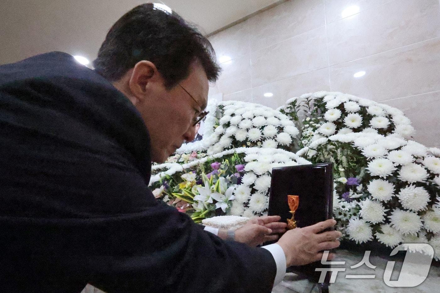 본문 이미지 - 김민석 국무총리가 13일 오전 전남 완도군 완도읍의 한 장례식장을 찾아 화재현장에서 숨진 소방사에게 훈장을 수여하고 있다.(공동취재) 2026.4.13 