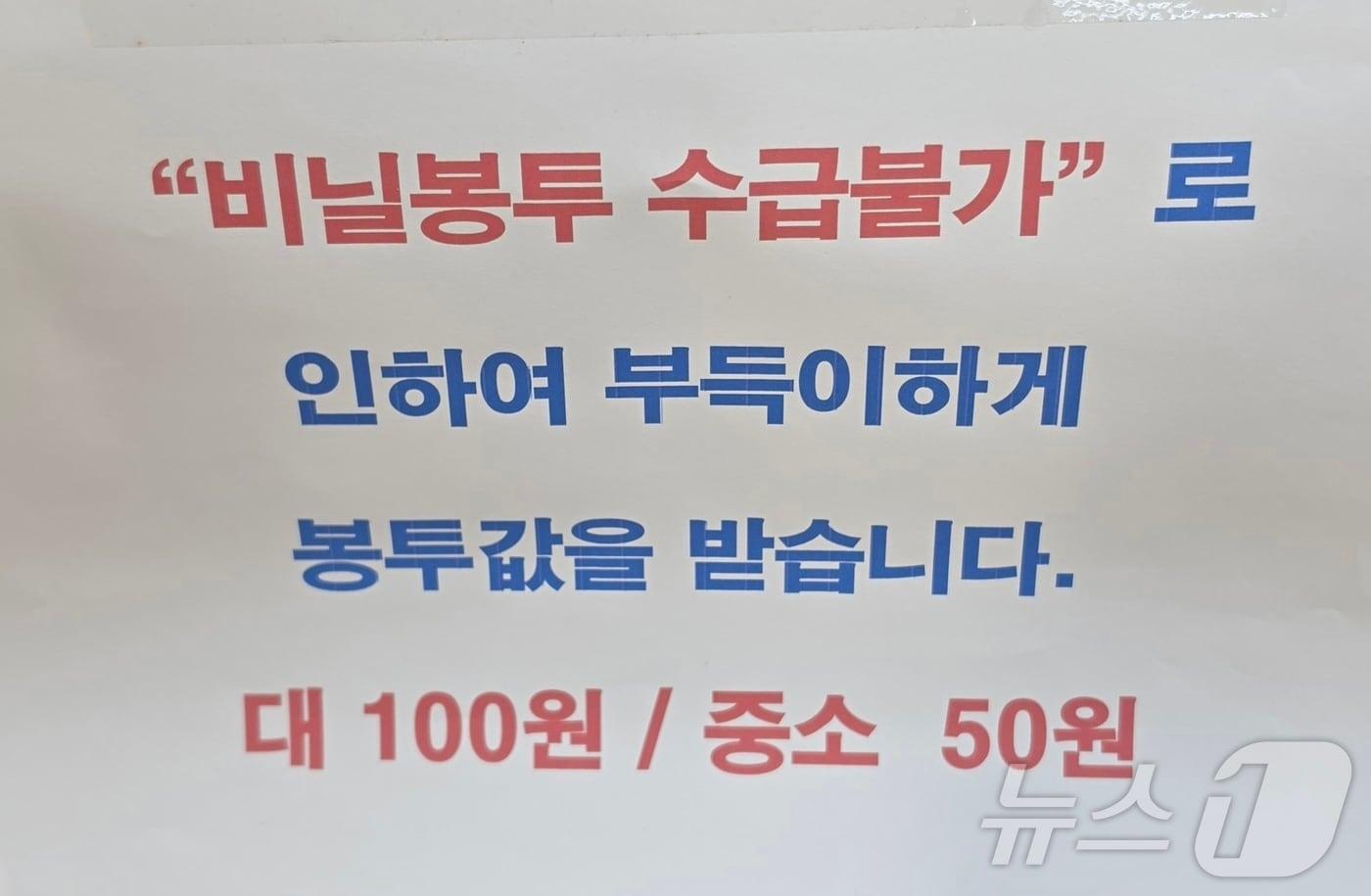 본문 이미지 - 2일 동네 상점 계산대에 적힌 이제 봉툿값을 별도로 받는다는 문구. ⓒ 뉴스1 이재상 기자