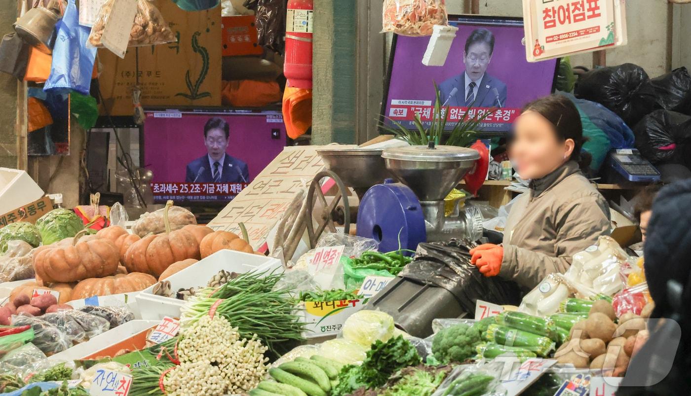 본문 이미지 - 26조2000억 원 규모 추가경정예산안에 민생회복 소비쿠폰 지급이 포함된 가운데 2일 서울 시내 한 전통시장에 이재명 대통령의 시정 연설이 TV에 나오고 있다. 2026.4.2 ⓒ 뉴스1 
