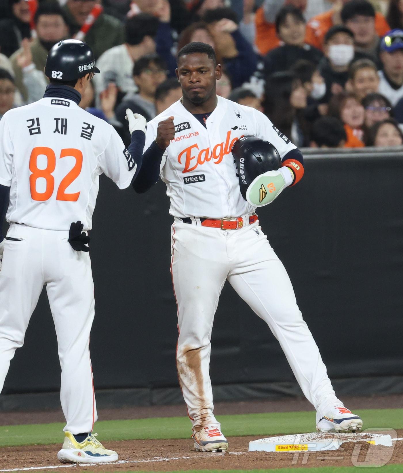 본문 이미지 - 2일 대전 한화생명볼파크에서 열린 2026 신한 SOL KBO리그 KT 위즈와 한화 이글스의 경기 4회말 1사 1루 상황, 1루주자 한화 페라자가 문현빈 안타에 3루에 세이프 되며 김재걸 코치와 하이파이브 하고 있다. 2026.4.2 ⓒ 뉴스1 김기남 기자
