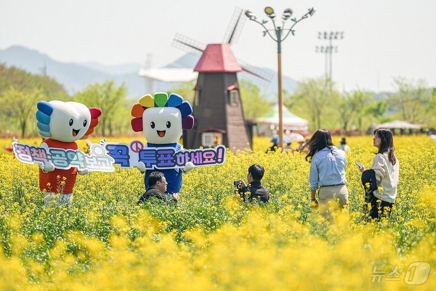 본문 이미지 - 경남도선거관리위원회가 20일 경남 창녕군 남지읍 유채꽃밭에서 제9회 전국동시지방선거 투표 참여를 독려하고 있다.(경남선관위 제공. 재판매 및 DB금지) ⓒ 뉴스1 강정태 기자