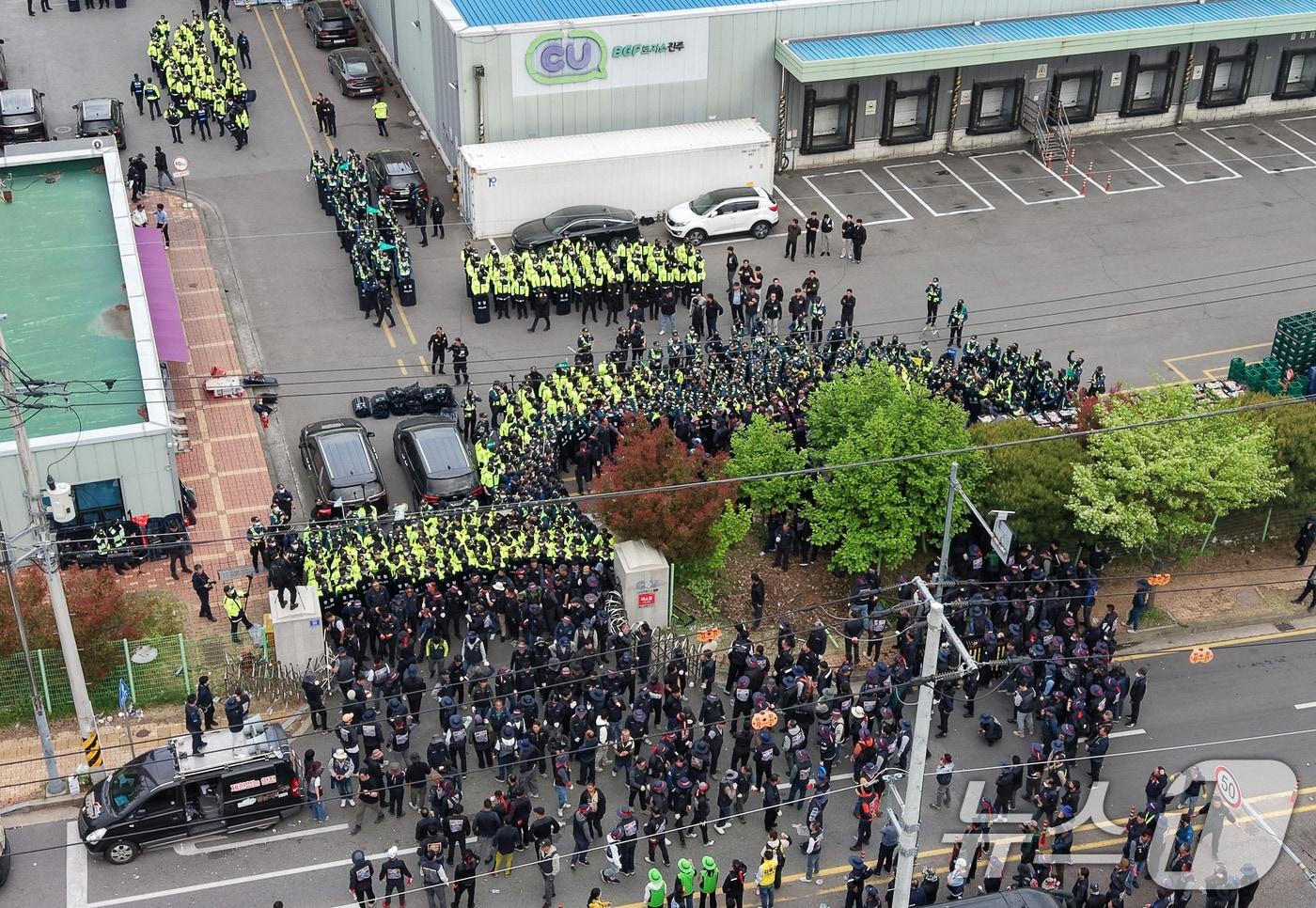 본문 이미지 - 20일 경남 진주시 정촌면 CU 진주물류센터 앞에서 진입을 시도하는 화물연대 노조원들을 경찰이 막아서고 있다. 이날 현장에서는 화물차와 집회 참가자 3명이 충돌해 1명이 숨지고 2명이 다치는 사고가 발생했다. 2026.4.20 ⓒ 뉴스1 윤일지 기자