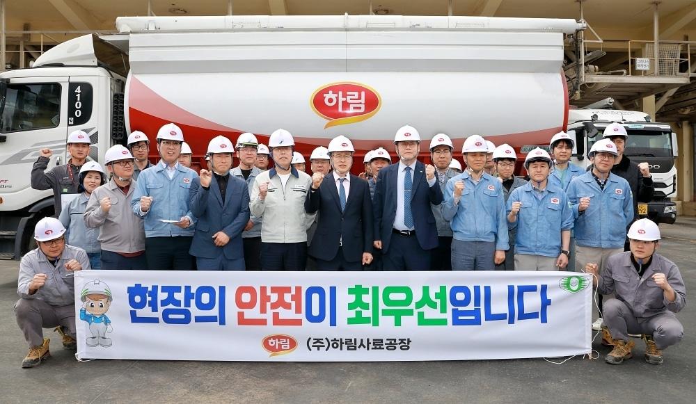 본문 이미지 -  22일 전북 김제사료공장에서 열린 사료 생산능력 증설(CAPA UP 20%) 기공식에서 ㈜하림 임직원 및 현장 관계자들이 사료 운송 차량 앞에서 '현장의 안전이 최우선입니다'라는 현수막을 들고 무재해 및 성공적인 공사를 다짐하며 파이팅을 외치고 있다. (하림 제공)