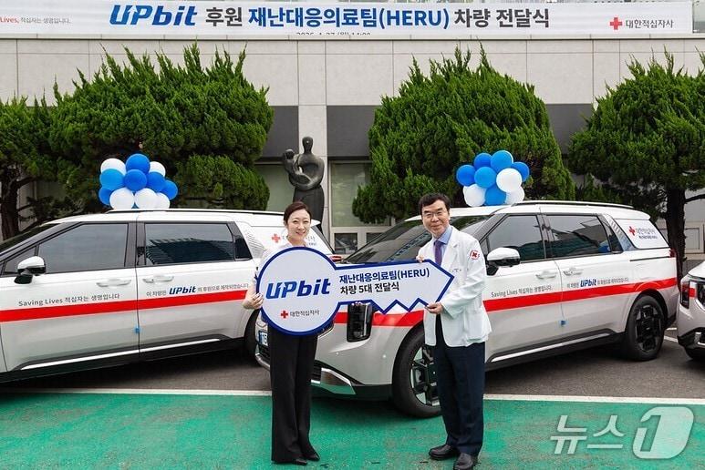 본문 이미지 - 두나무와 대한적십자사가 재난대응의료팀(HERU) 차량전달식 개최를 기념해 사진을 촬영하고 있다. 좌측부터 이수민 두나무 임팩트비즈니스실 실장, 채동완 대한적십자사 서울적십자병원장 겸 의료원장. 두나무 제공.