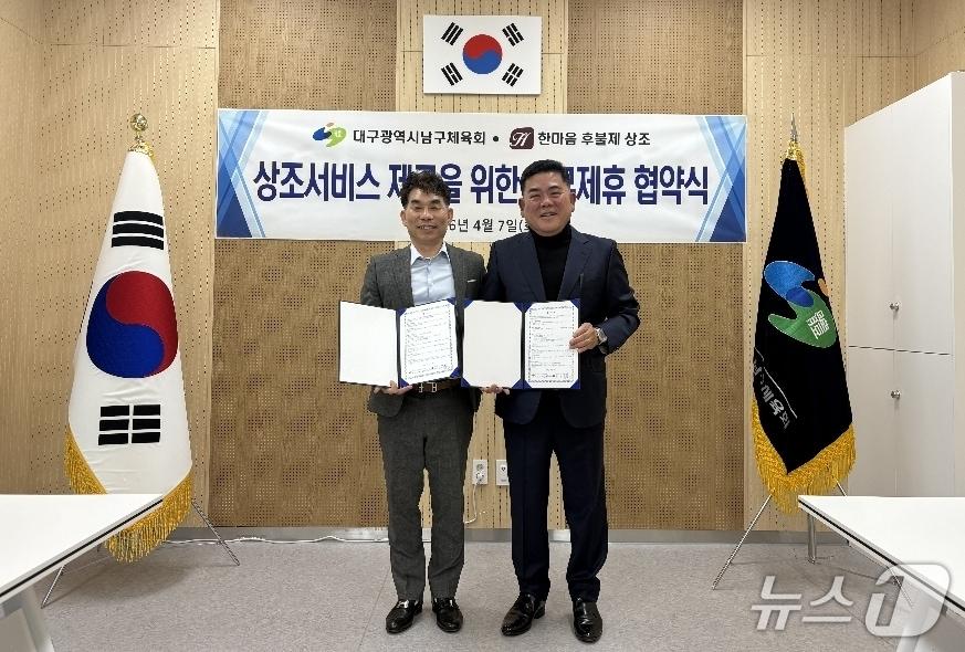 본문 이미지 - 권복만 대구 남구체육회장(왼쪽)과 김수열 한마음 후불제 상조회 대표가 건전한 장례문화 정착을 위한 업무협약을 체결한 뒤 협약서를 펼쳐 보이고 있다.(대구 남구체육회 제공, 재판매 및 DB 금지)