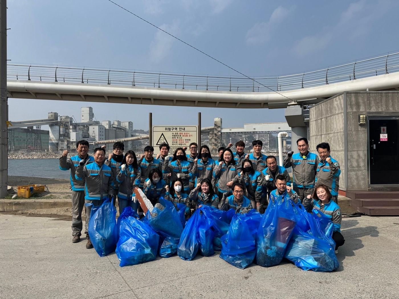 본문 이미지 - 삼표시멘트 임직원이 지난달 27일삼척시 관내 주요 하천의 수질 개선과 수자원 보호를 위한 환경 정화활동을 실시한 후 기념촬영을 하고 있다.(삼표시멘트제공)