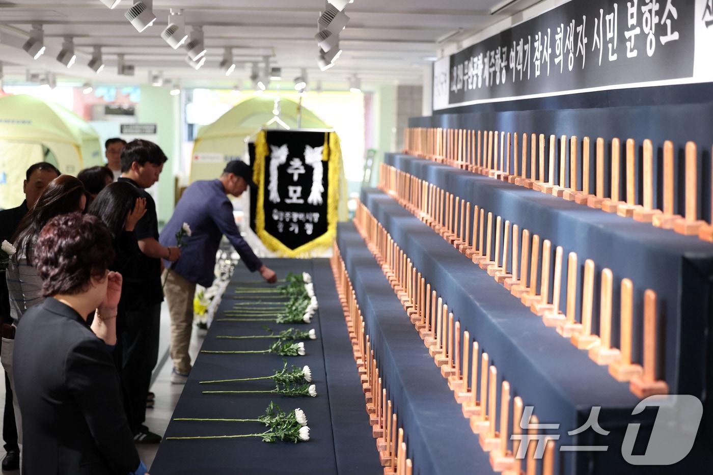 본문 이미지 - 10일 오전 광주 동구 YMCA 1층에 마련된 12·29 무안공항 제주항공 여객기 참사 시민 분향소에서 유가족이 헌화하고 있다. 2026.5.10 ⓒ 뉴스1 이승현 기자