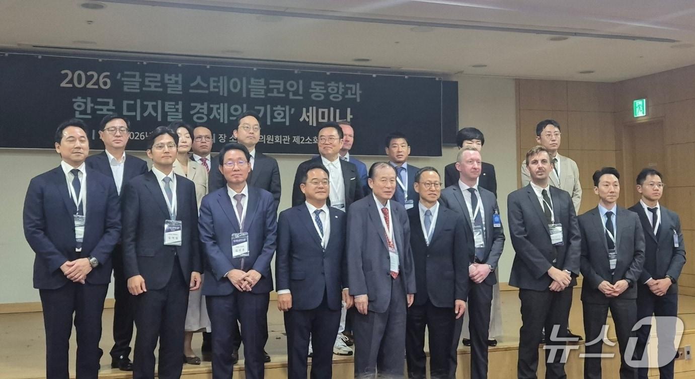 본문 이미지 -  12일 서울 여의도 국회의사당에서 열린 '글로벌 스테이블코인 동향과 한국 디지털 경제의 기회' 세미나 참석자들이 기념촬영을 하고 있다. 2026.5.12,./뉴스1