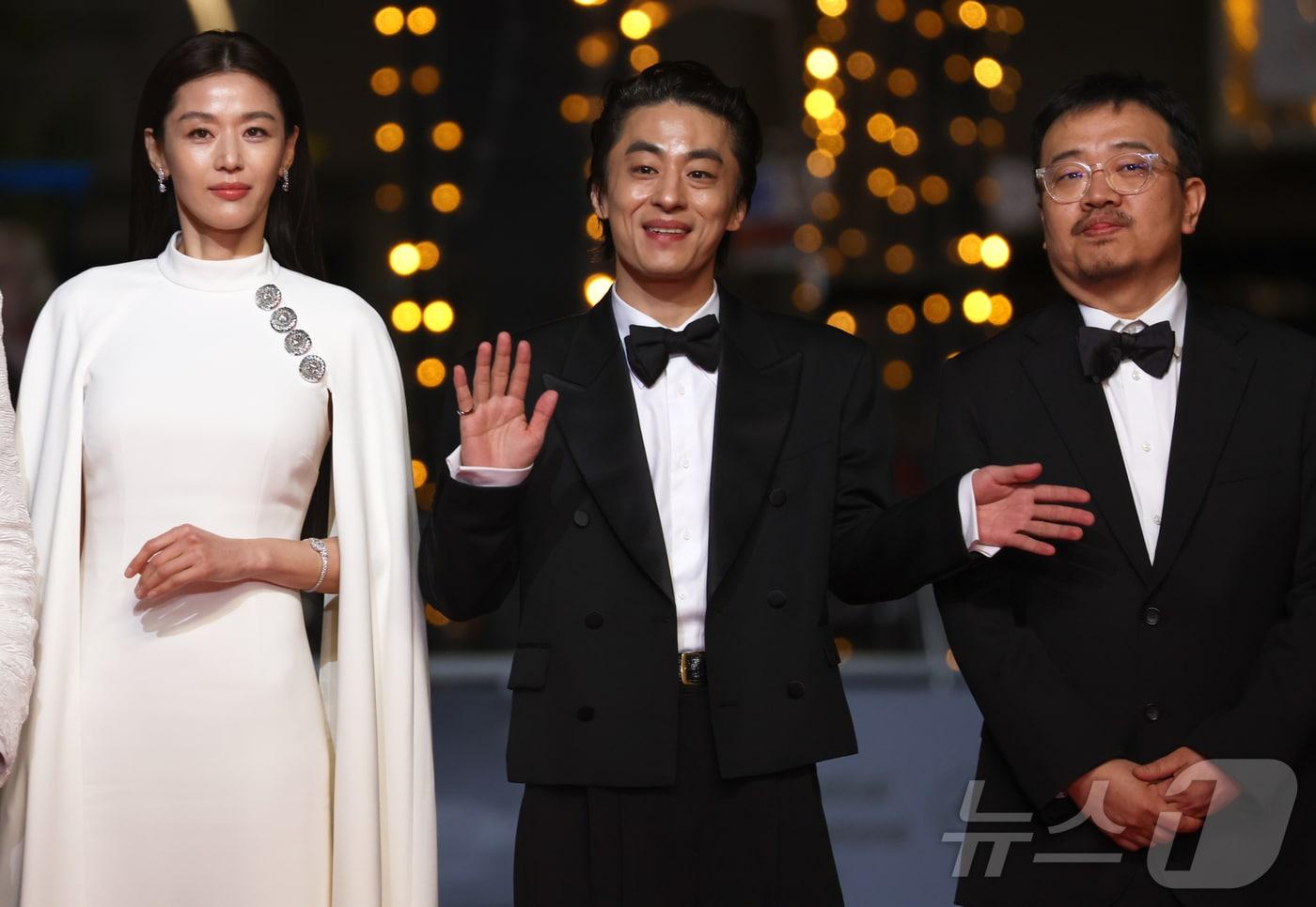 본문 이미지 - 16일(현지시간) 프랑스 남부 소도시 칸 팔레 데 페스티발(Palais des Festivals) 뤼미에르 대극장에서 열린 제79회 칸 국제영화제 미드나잇 스크리닝 초청작 ‘군체’ 공식 시사회에서 연상호 감독과 주연배우 전지현, 구교환이 레드카펫에 오를 준비를 하고 있다. 2026.5.16 ⓒ 뉴스1 이준성 특파원