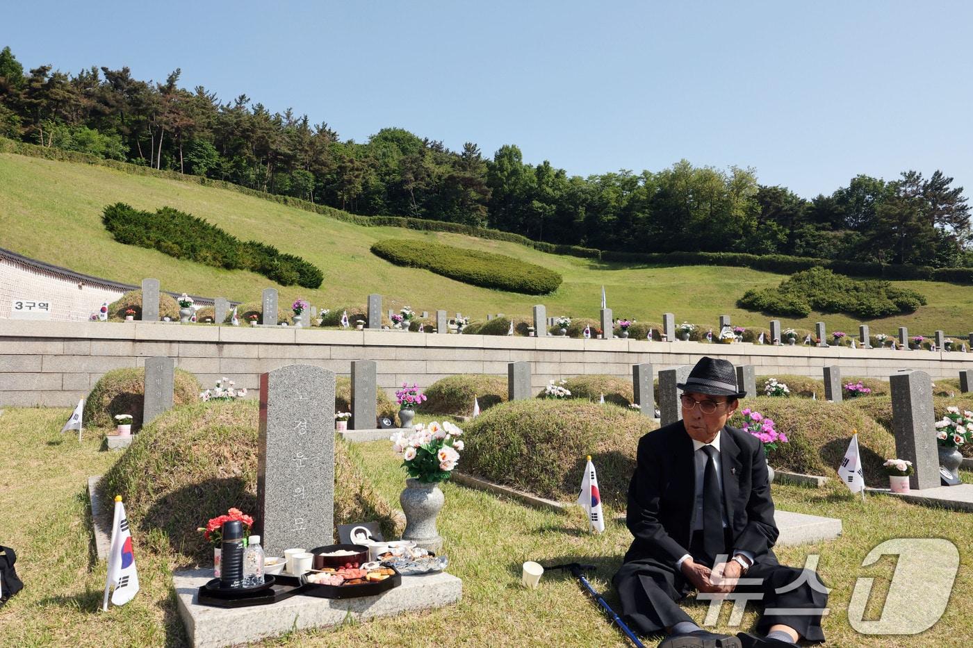 본문 이미지 - 제 46주년 5·18민주화운동 기념일을 하루 앞둔 17일 노경운 열사 묘역 앞에서 한 어르신이 동생을 그리워하며 차례상을 차리고 있다. ⓒ 뉴스1 박지현 기자