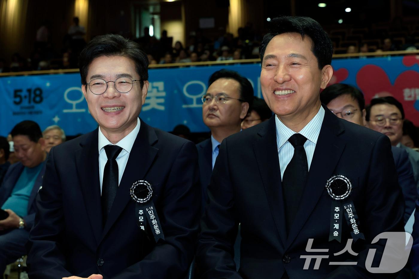 본문 이미지 - 정원오 더불어민주당 서울시장 후보(왼쪽)와 오세훈 국민의힘 서울시장 후보가 18일 오전 서울 중구 서울시청 다목적홀에서 열린 5.18민주화운동 제46주년 서울기념식에서 대화를 나누며 환하게 웃고 있다. 2026.5.18 ⓒ 뉴스1 박정호 기자