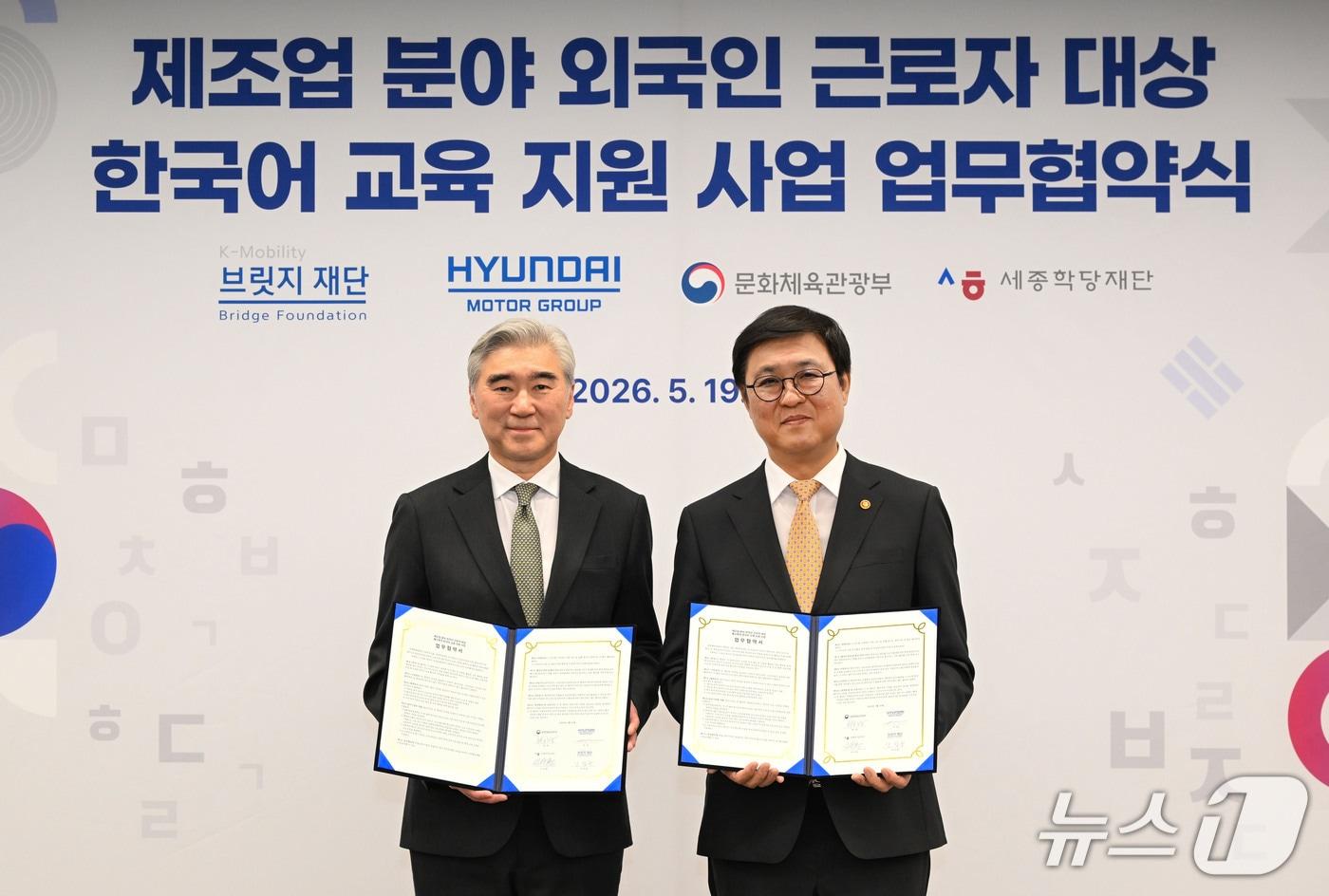 본문 이미지 - 19일 국립현대미술관에서 열린 '제조업 분야 외국인 근로자 대상한국어 교육 지원 사업 업무협약식'에서 성 김 현대자동차그룹 전략기획담당 사장(왼쪽)과 최휘영 문화체육관광부 장관이 기념촬영을 한 모습(현대차그룹 제공). 2026.5.19.