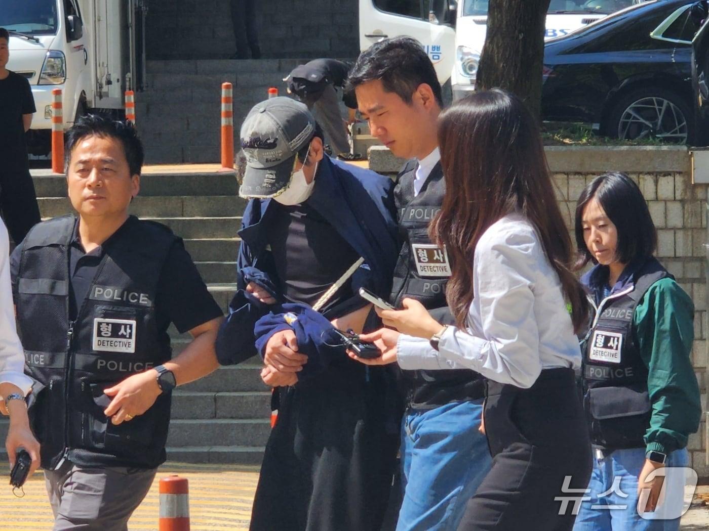 본문 이미지 - 22일 배우 김규리의 자택에 무단 침입해 강도 행각을 벌인 40대 남성이 서울중앙지법 서관으로 들어가고 있다. 2026.05.22/ⓒ 뉴스1 권진영 기자