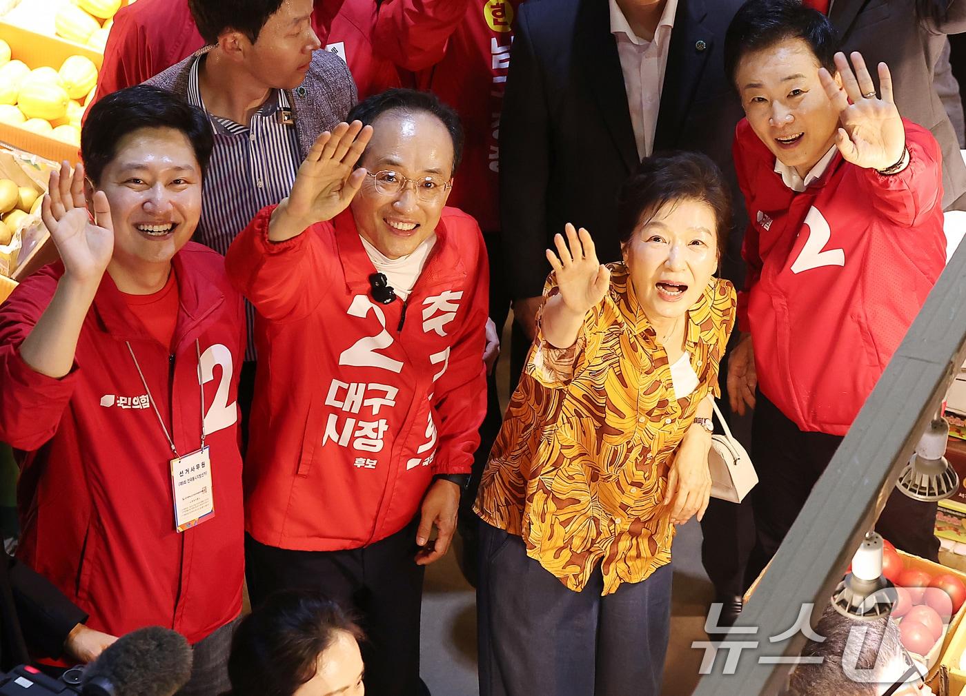 본문 이미지 - 박근혜 전 대통령이 23일 오후 대구 북구 칠성시장을 찾아 추경호 국민의힘 대구시장 후보 등 일행과 함께 이동하며 손을 흔들고 있다. 2026.5.23 ⓒ 뉴스1 공정식 기자