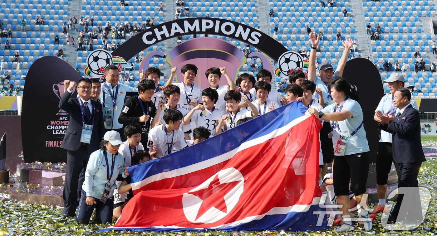 본문 이미지 - 23일 오후 경기 수원시 수원종합운동장에서 열린 2025-2026 아시아축구연맹(AFC) 여자 챔피언스리그(AWCL) 결승 북한 내고향여자축구단과 도쿄 베르디의 경기에서 우승을 거둔 내고향 선수들이 인공기를 펼쳐 기념 촬영을 하고 있다. 2026.5.23 ⓒ 뉴스1 박지혜 기자