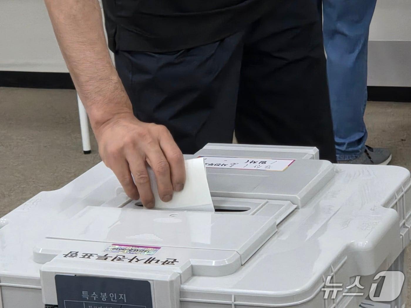 본문 이미지 - 제9회 전국동시지방선거 사전투표 첫날인 29일 대전시청 사전투표소에서 투표를 마친 유권자가 투표함에 표를 넣고 있다. ⓒ 뉴스1 김종서 기자