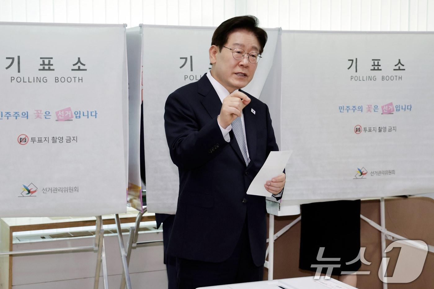 본문 이미지 - 이재명 대통령이 제9회 전국동시지방선거 사전투표 첫날인 29일 서울 종로구 삼청동 주민센터에서 사전 투표 중 기표 도장 관련 문의를 하고 있다. 2026.5.29 ⓒ 뉴스1 허경 기자