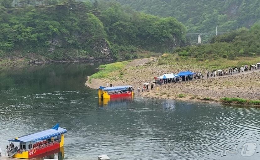 본문 이미지 - 조선 6대 임금 단종을 다룬 영화 '왕과 사는 남자'(왕사남)가 1670만여 누적 관객을 동원하면서 흥행한 가운데, 5월 첫 일요일인 3일 단종 유배지였던 강원 영월군 청령포도 몰려든 여행객들로 인기를 끌고 있다. 이곳 여행객들은 이날 비 날씨에도 우산을 들고 청령포에서 배를 타기 위해 대기하는 모습을 보여줬다. 2026.5.3 ⓒ 뉴스1 신관호 기자