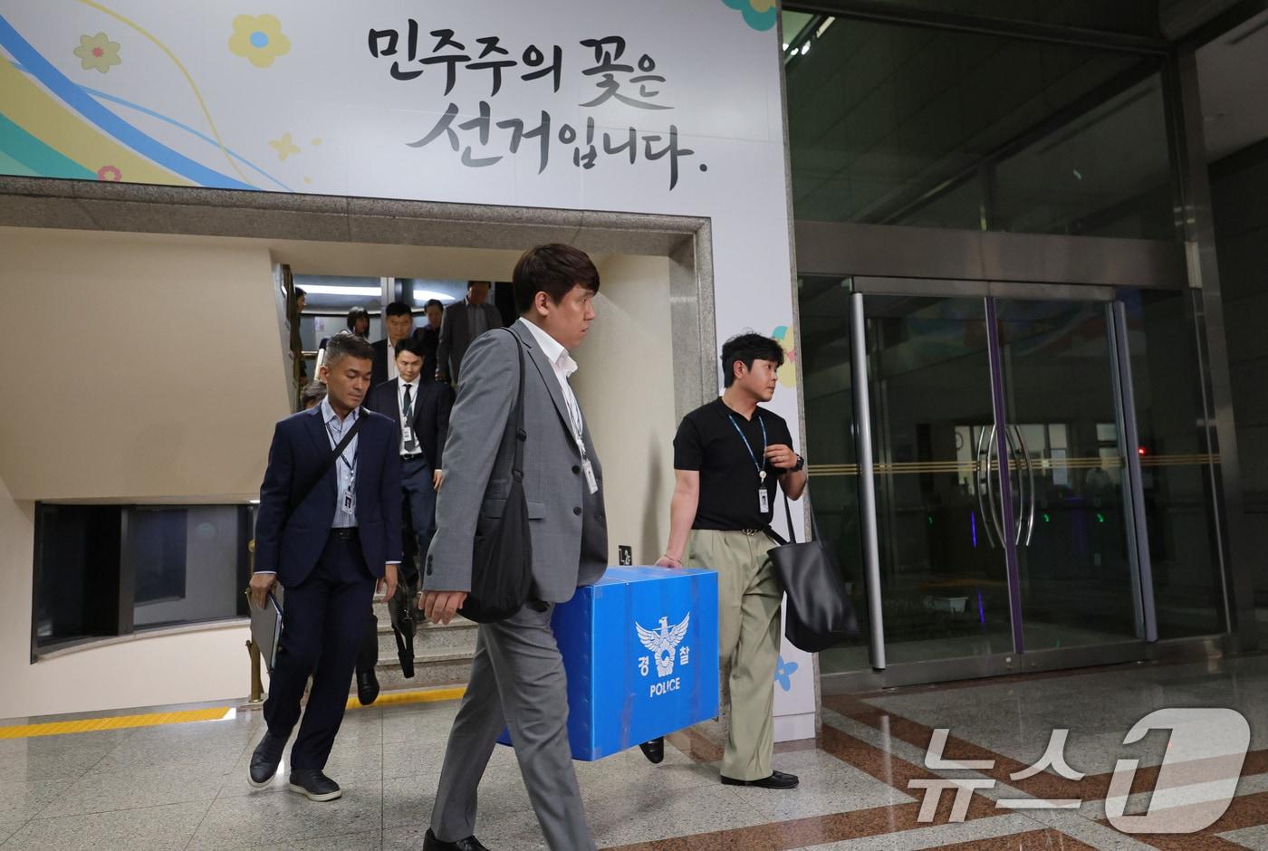 본문 이미지 - 6·3 지방선거 투표용지 부족 사태를 수사하는 검경 합동수사본부 수사관들이 11일 경기 과천시 중앙선거관리위원회에 대한 압수수색을 마친 후 압수품 상자를 들고 이동하고 있다. (공동취재) 2026.6.11 ⓒ 뉴스1 이호윤 기자