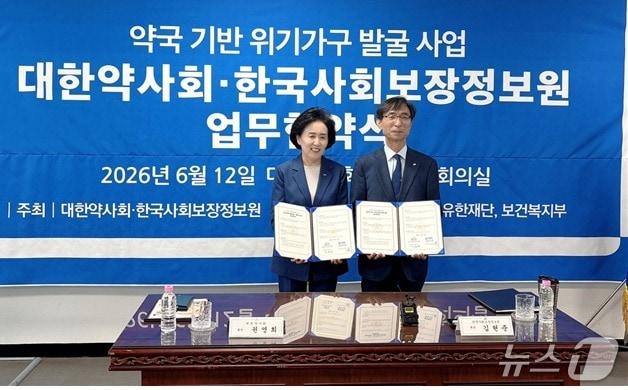 본문 이미지 - 권영희 대한약사회장(왼쪽)이 김현준 한국사회보장정보원장과 업무협약을 체결한 뒤 기념촬영을 하고 있다.(대한약사회 제공)