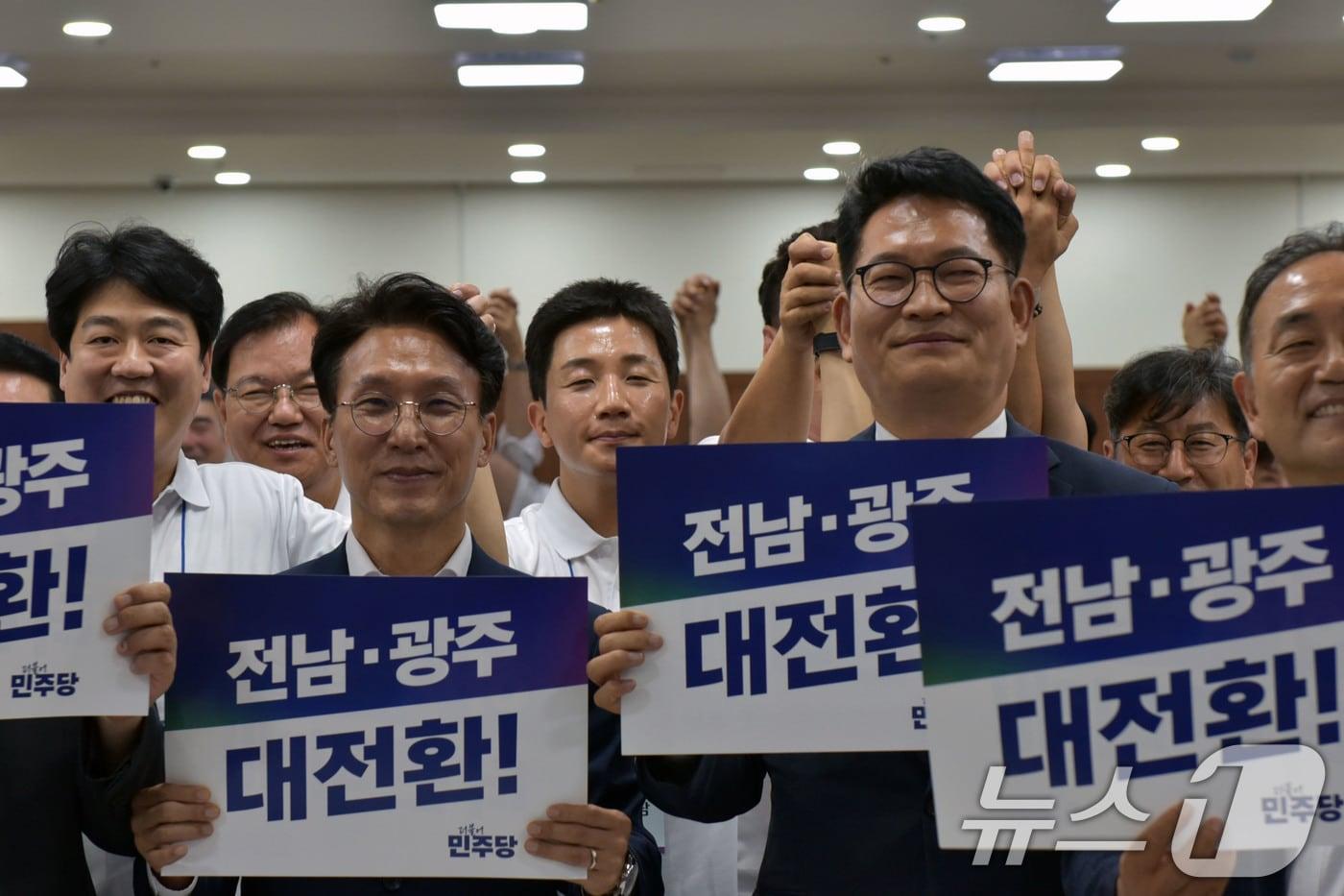 본문 이미지 - 김민석 국무총리와 송영길 더불어민주당 의원이 16일 전남 보성 다비치콘도에서 열린 제9회 전국동시지방선거 전남광주통합특별시의원 당선인 워크숍에서 손피켓을 들고 기념촬영을 하고 있다. 2026.6.16 ⓒ 뉴스1 김성준 기자