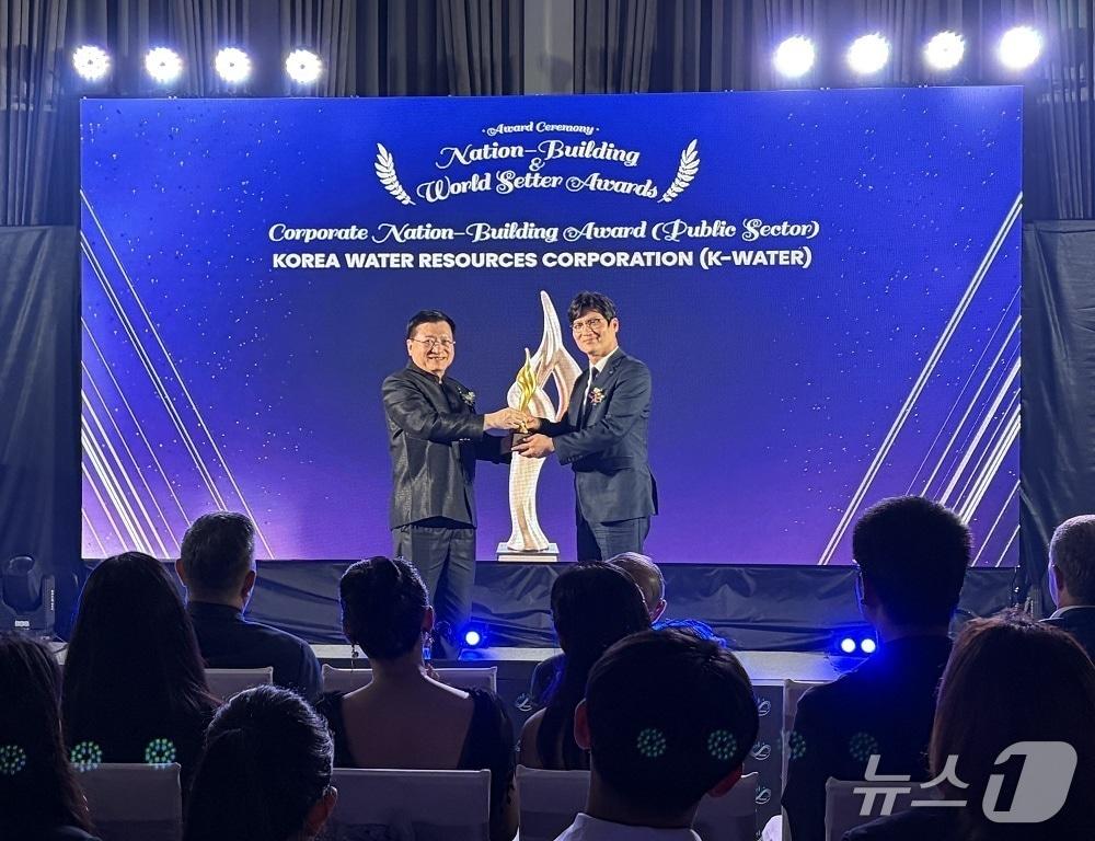 본문 이미지 - 한국수자원공사가 'Nation-Building Awards' 공공부문 기업상을 수상한 후 관계자가 수상 트로피를 들고 기념사진을 촬영하고 있다.(한국수자원공사 제공.재판매 및 DB 금지)/뉴스1