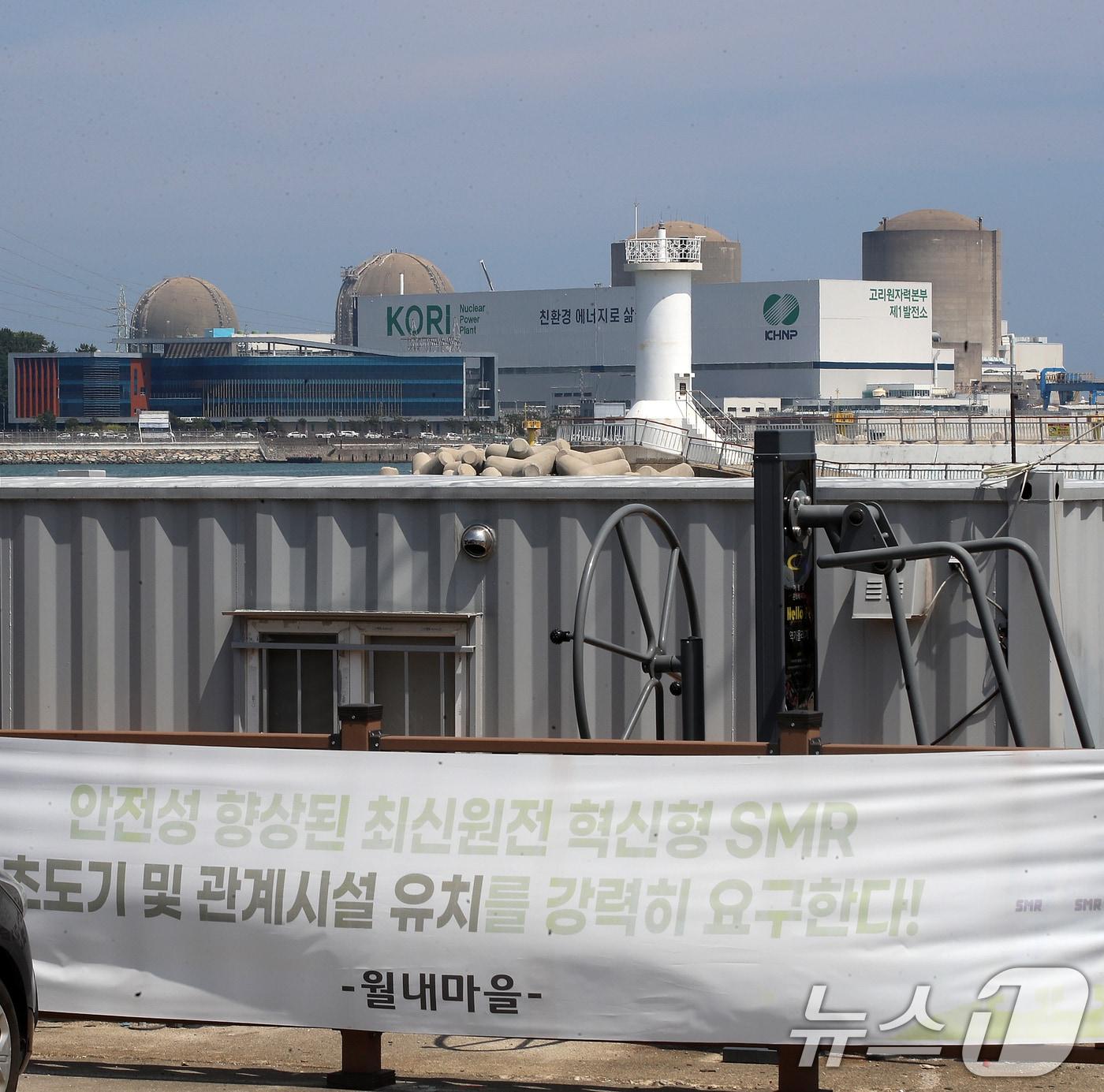 본문 이미지 - 지난 18일 부산 기장군 장안읍 월내방파제 인근에 내걸린 SMR 기장군 유치를 바라는 내용의 현수막 뒤로 고리1, 2, 3, 4호기가 보이고 있다.ⓒ 뉴스1 윤일지 기자