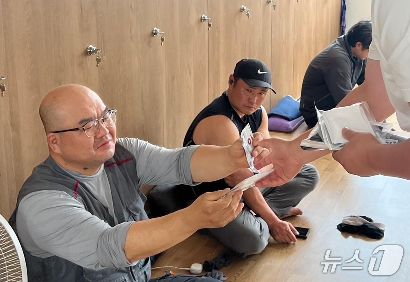 본문 이미지 - 괴산군이 소속 현장 근로자에게 온열질환 예방 물품을 지급하고 있다.(괴산군 제공. 재판매 및 DB금지)/뉴스1