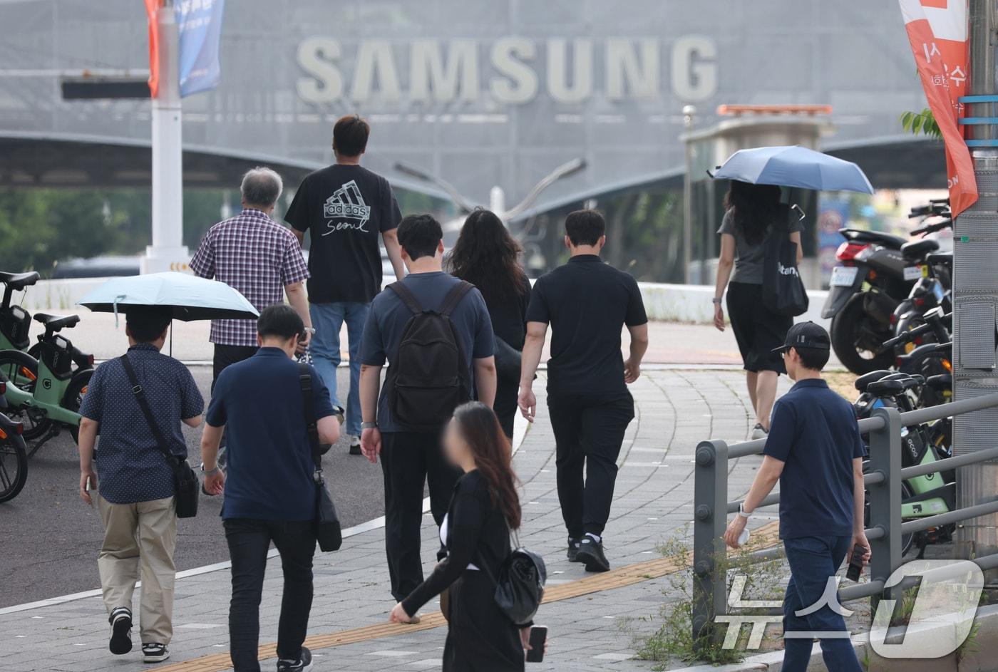 본문 이미지 - 경기 수원시 영통구 삼성전자 수원캠퍼스에서 디바이스경험(DX)부문 직원들이 반도체(DS)부문과의 성과급 격차에 항의하기 위해 검은 옷을 입고 출근하고 있다. 2026.6.23 ⓒ 뉴스1 김영운 기자