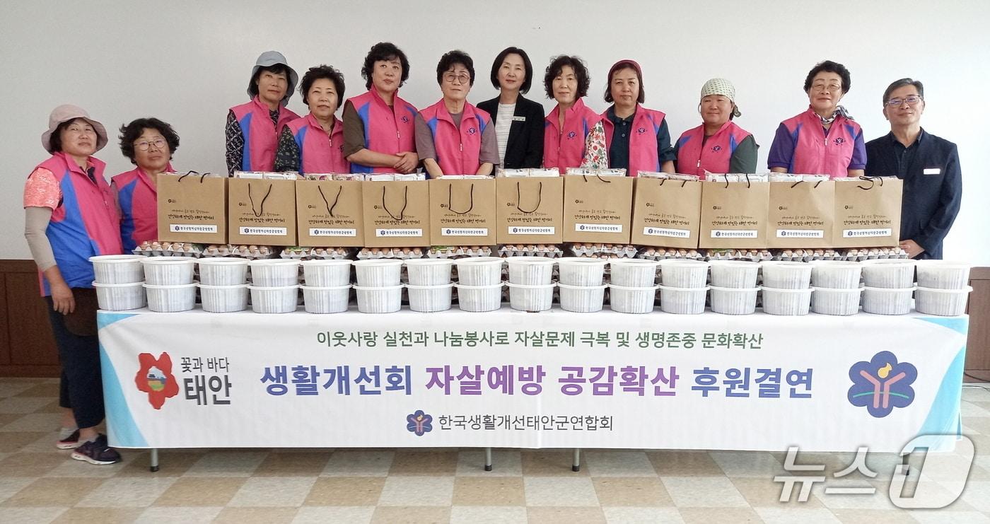 본문 이미지 - 태안군 생활개선회 회원들이 독거노인에게 전달할 물품을 진열해 놓고 기념촬영을 하고 있다.(태안군 제공. 재판매 및 DB금지)/뉴스1