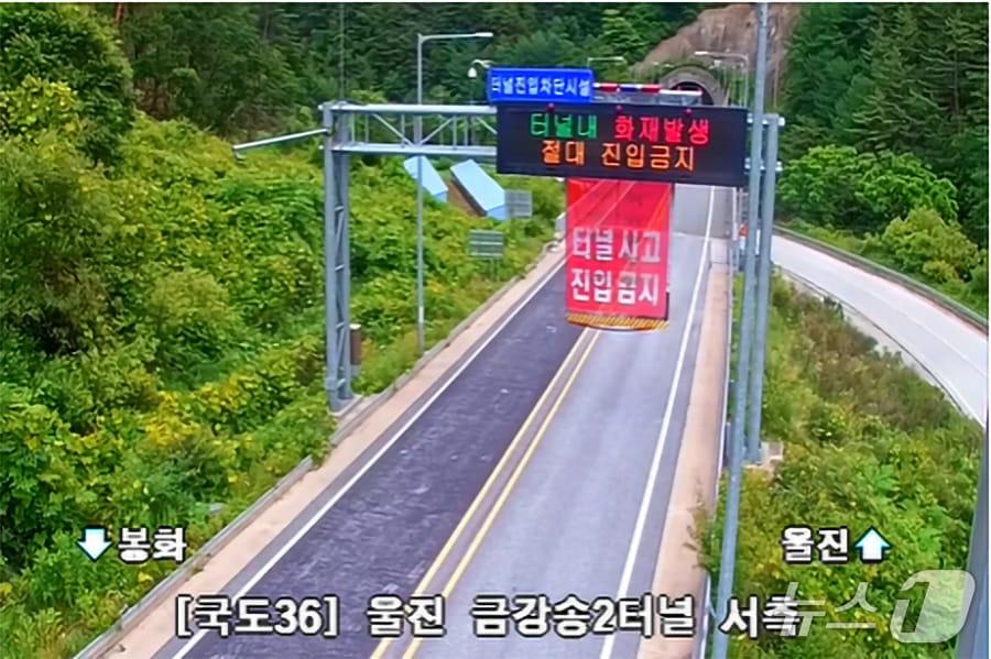본문 이미지 - 23일 오후 1시 4분쯤 국도 36호선 경북 울진군 금강송면 쌍전리 금강송 2터널을  달리던 승용차에 불이 나 양방향 통행이 차단되고 있다.(국도유지관리소 CCTV갈무리, 재판매 및 DB금지) 2026.6.23/뉴스1 
